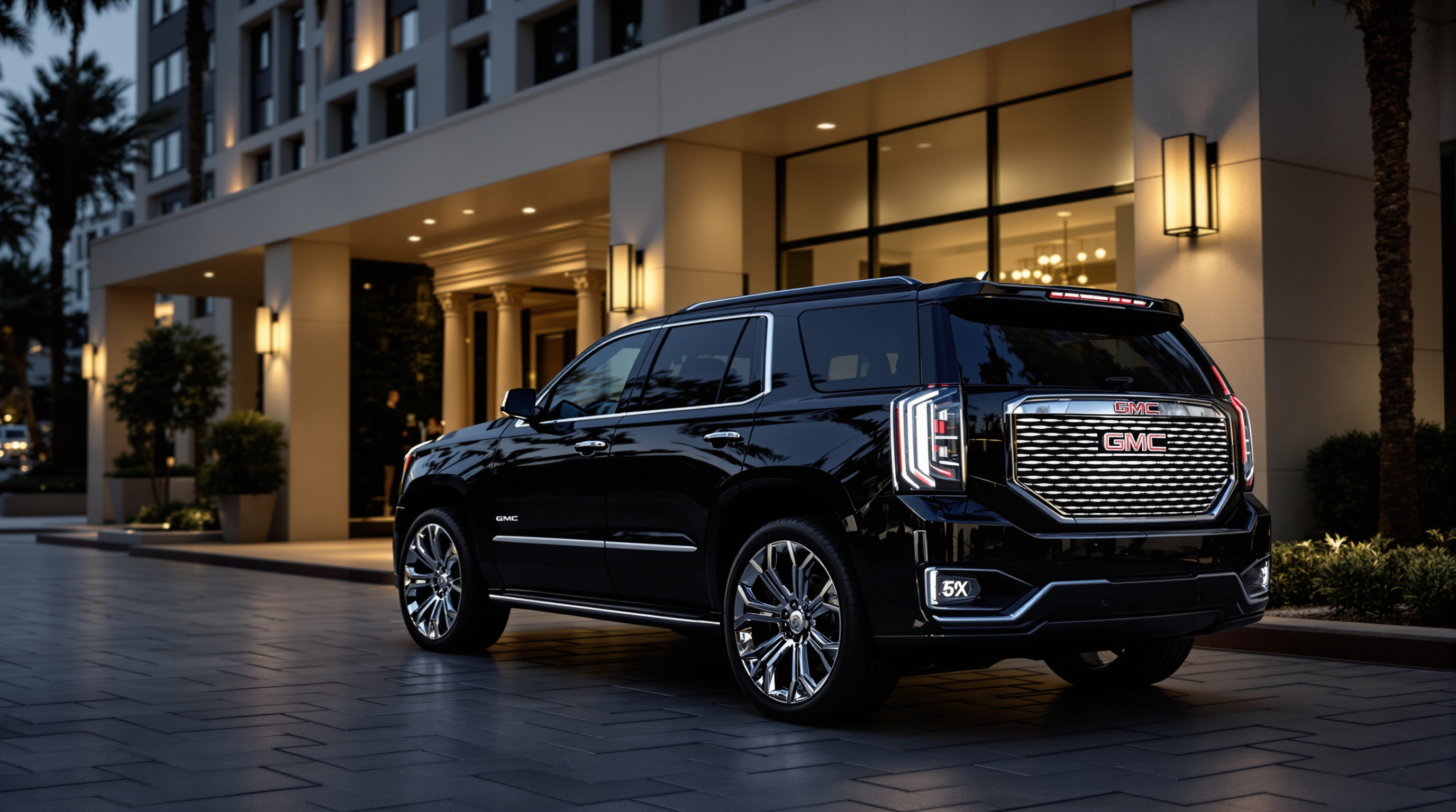 why us elite luxury services - luxury black GMC Denali SUV parked in front of an upscale San Diego hotel lobby entrance,